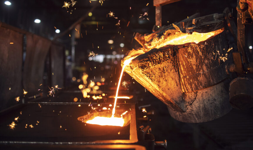 Molten metal casting in foundry. Filling mold with hot liquid iron and producing iron components in steel plant.