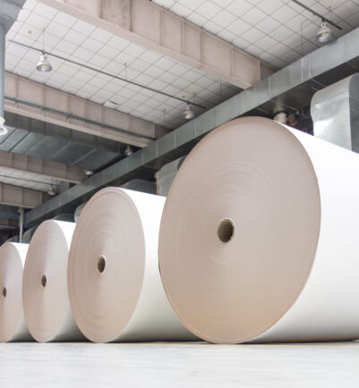 Huge industrial rolls placed in a warehouse