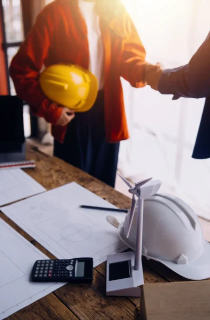 three-colleagues-discussing-data-working-tablet-laptop-with-architectural-project-construction-site-desk-office (1)